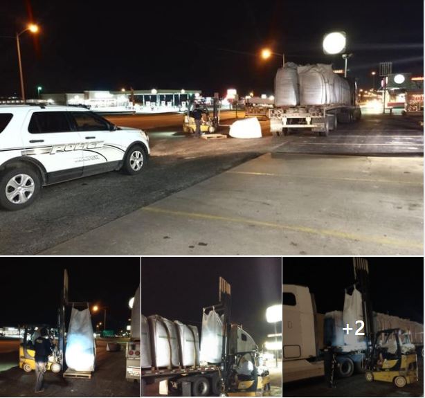 Social Media Post Pictures Image of a police car behind a semi truck that had dropped a bag of peat moss. A forklift can be seen getting ready to move the bag of peat moss.