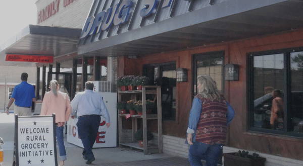 Storefront of one of the stores featured on the 2026 Kansas Rural Grocery Road Trip, the store in Howard, Kansas, with a sign out front reading "Welcome Rural Grocery Initiative"